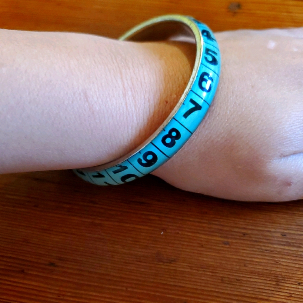Tape measure bangle bracelet.